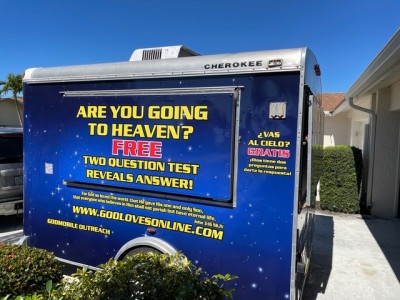 Outdoor booth with sign that says, "Are you going to heaven?"