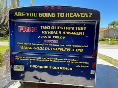 Outdoor booth with sign that says, "Are you going to heaven?"
