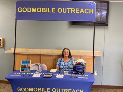 Indoor table with banner that reads, "Godmobile Outreach"